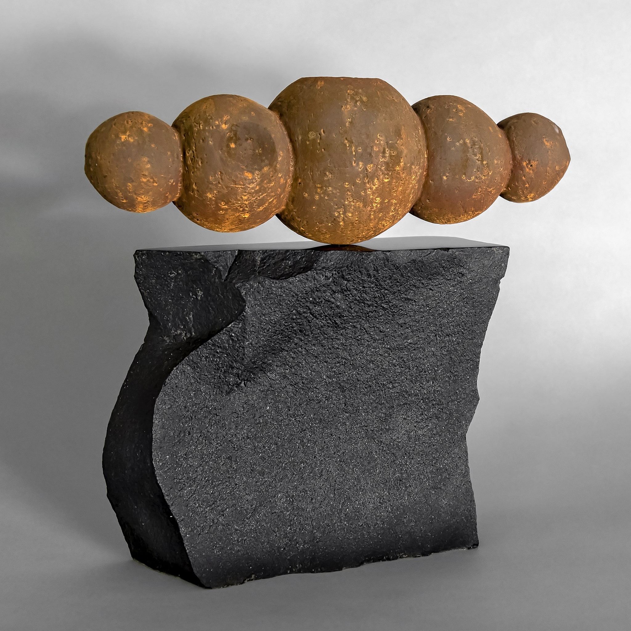 Geo Spheres, 12" x 13" x 4", clay with iron oxide finish on black basalt