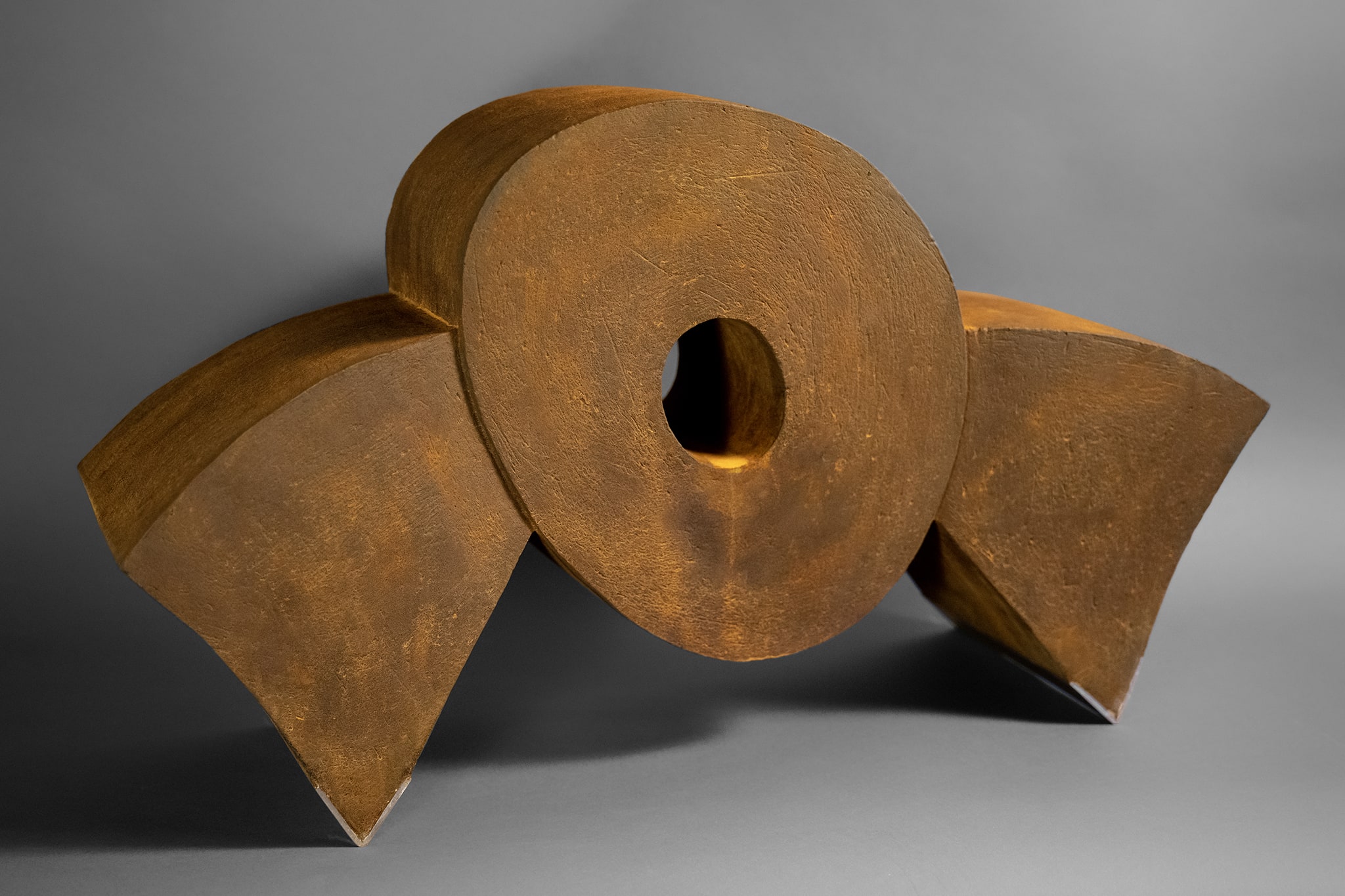 On Edge I, 12.5" H x 21.5" W x 7.5" D, clay with iron oxide finish, stainless steel